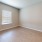 a room with a wood floor and a window