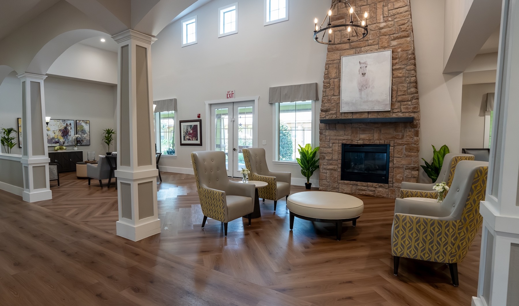 a spacious clubroom with a large fireplace