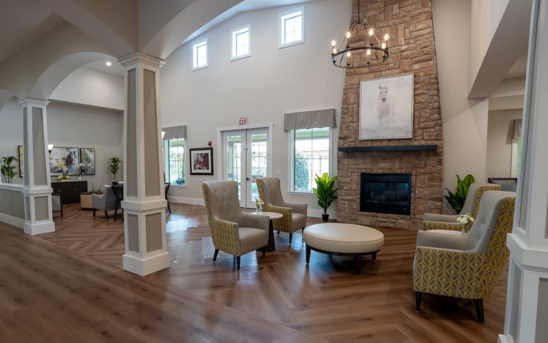a room with a fireplace and chairs