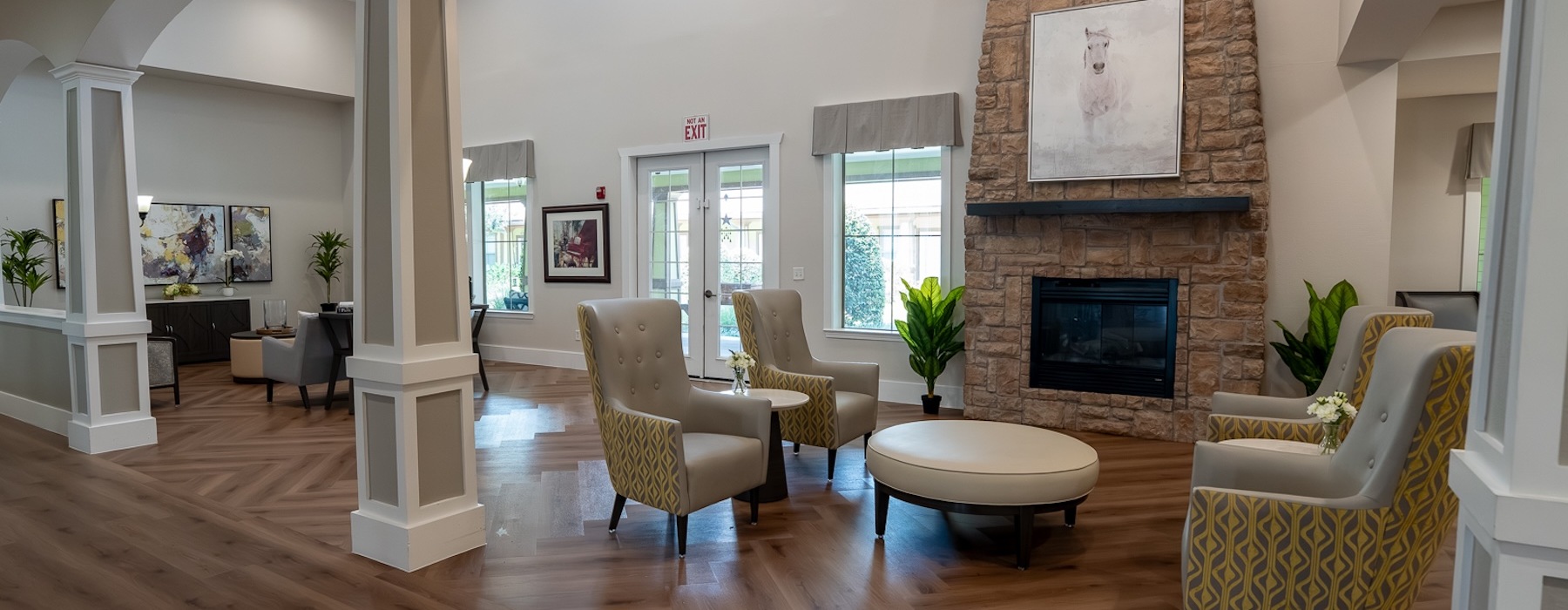 a room with a fireplace and chairs