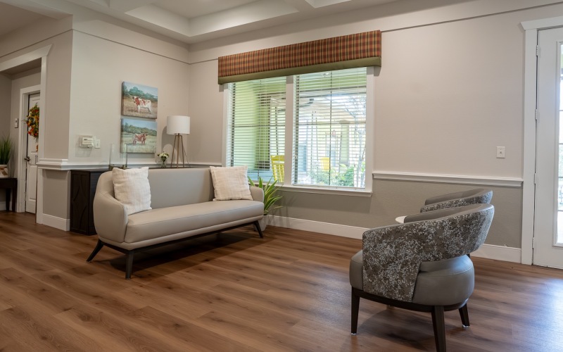 a couple of chairs and a table near a window