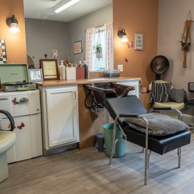 a hair salon room wit a sink