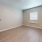 a room with a wood floor and a window