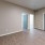a room with a wood floor and blue doors