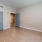 a room with a wood floor and white walls